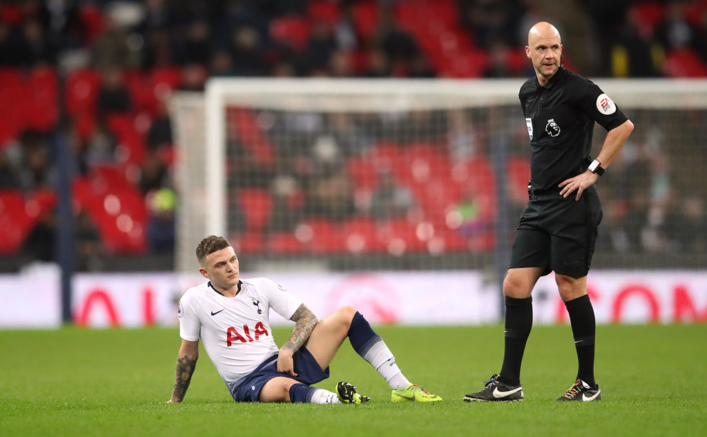 Tottenham Hotspur's Kieran Trippier (left) lays on the floor as referee Anthony Taylor looks on during the Premier League match at Wembley Stadium, London.