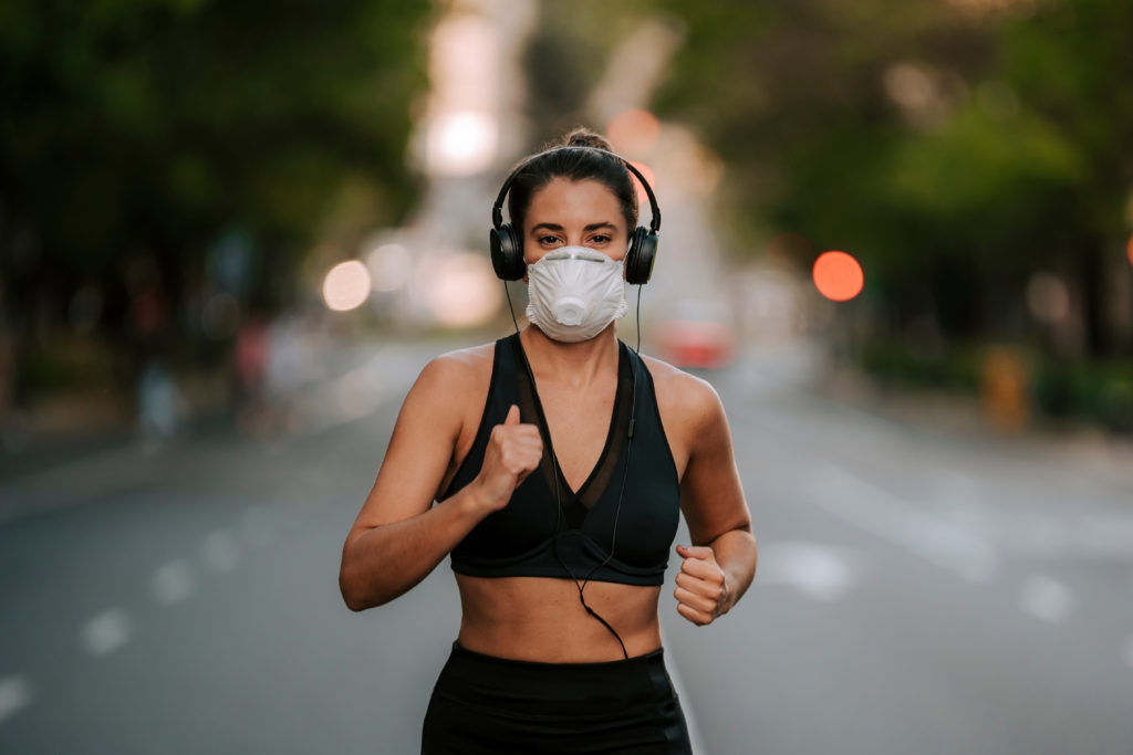 Woman does exercise in a face mask