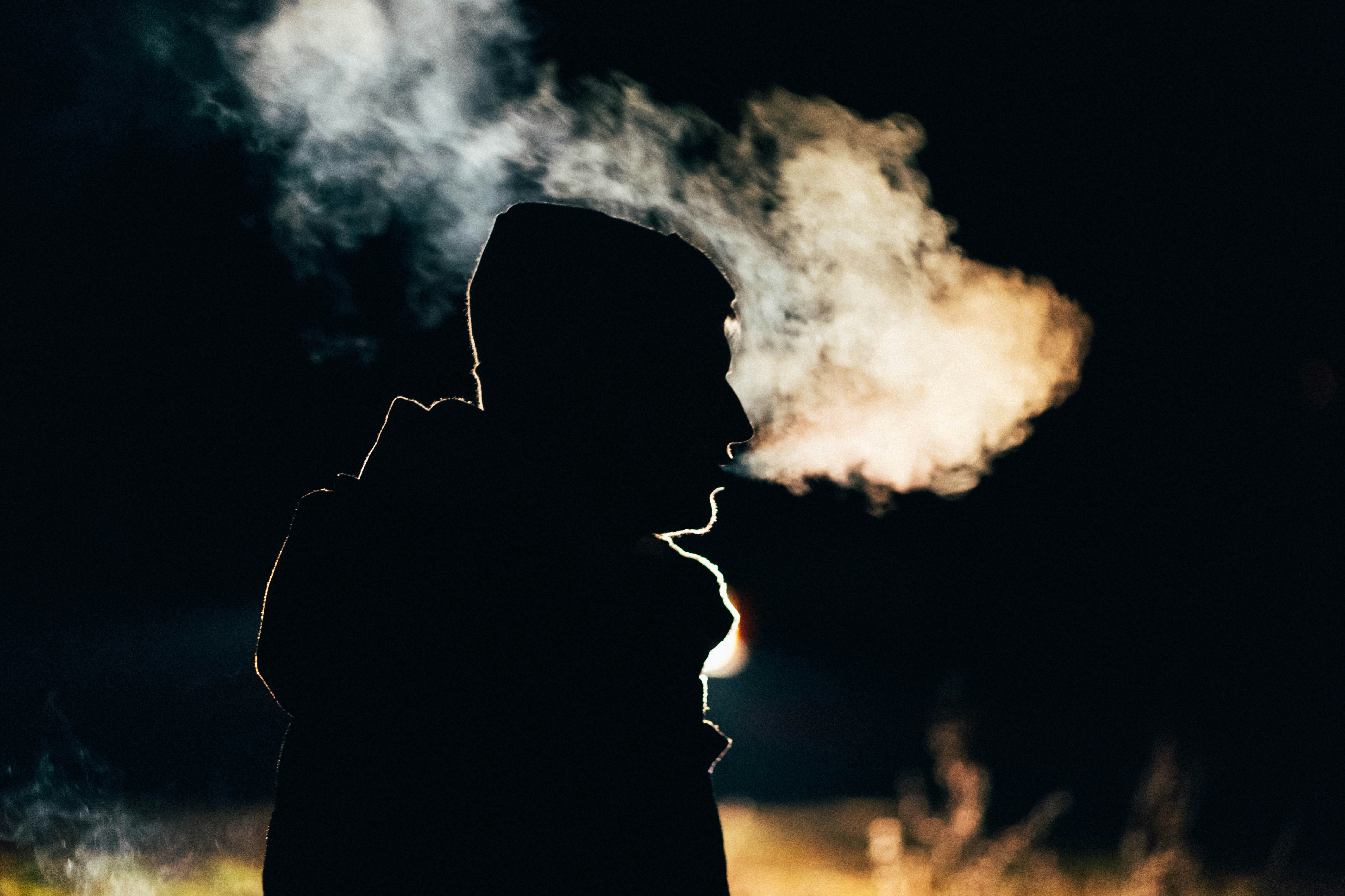 Man breathing out water moisture in cold weather